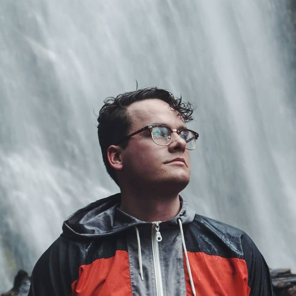 Joel Hiking with waterfall in background